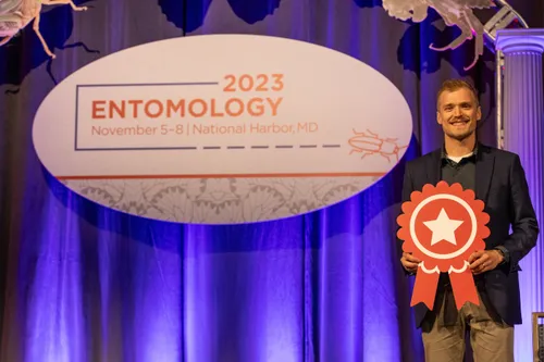 Holding the 2nd place ribbon at Entomology 2023